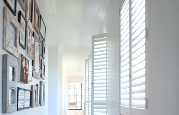 Plantation style security shutters in a hallway