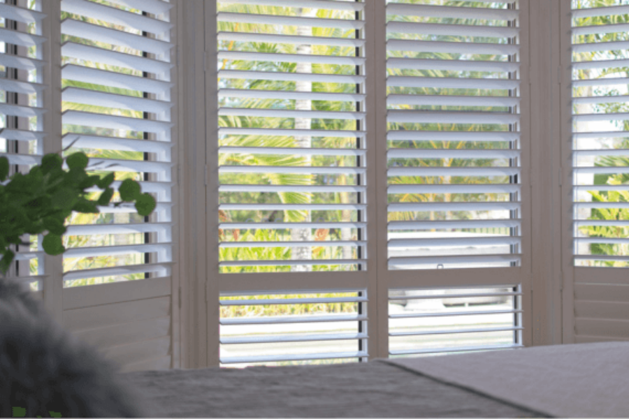 white plantation shutters installed in a bedroom