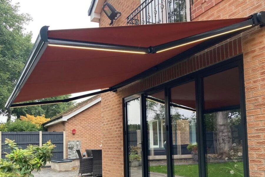 Motorised and customised awnings on a home which extends out over a patio and garden.