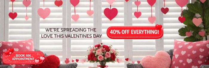 Valentine’s Day promotional banner with white plantation shutters background, pink heart decorations, red cushions, “We’re Spreading the Love This Valentine’s Day” headline, 40% off everything badge, and Book an Appointment button.